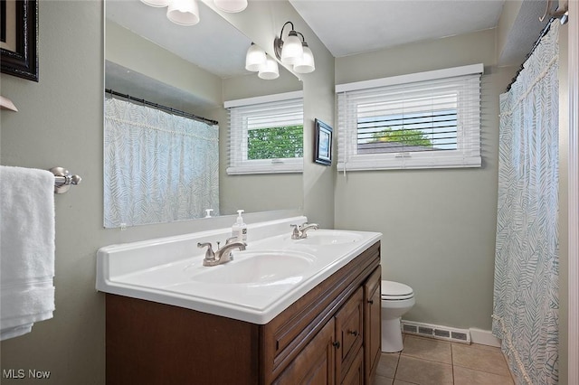 7278 Barton Hill Dr, Parma, OH 44129 - full bathroom featuring double vanity, toilet, tile patterned flooring, and baseboards