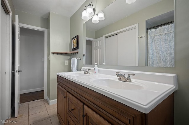 7278 Barton Hill Dr, Parma, OH 44129 - full bath with double vanity, tile patterned flooring, and baseboards
