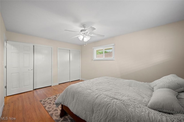 7278 Barton Hill Dr, Parma, OH 44129 - bedroom featuring multiple closets, light wood-style flooring, baseboards, and ceiling fan