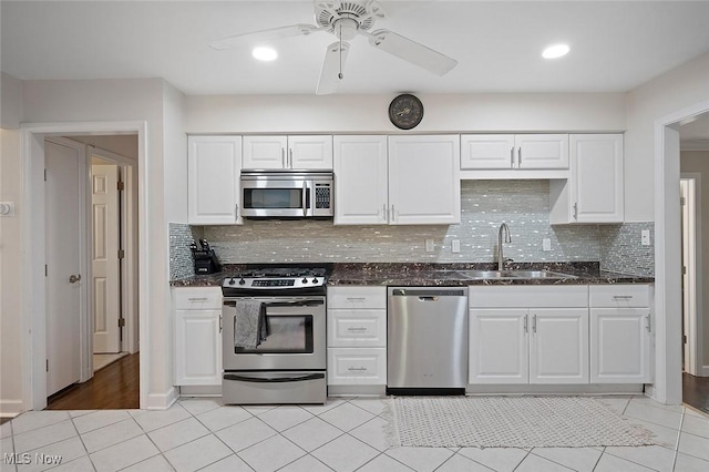 7278 Barton Hill Dr, Parma, OH 44129 - kitchen featuring stainless steel appliances, a sink, dark stone countertops, decorative backsplash, and recessed lighting