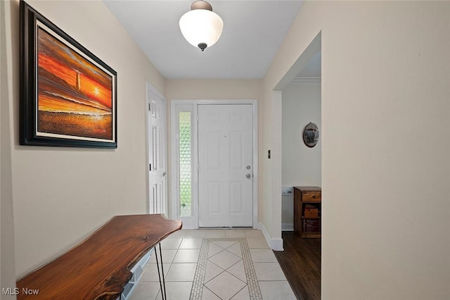 7278 Barton Hill Dr, Parma, OH 44129 - entryway with light tile patterned floors, baseboards, and inlaid floor details