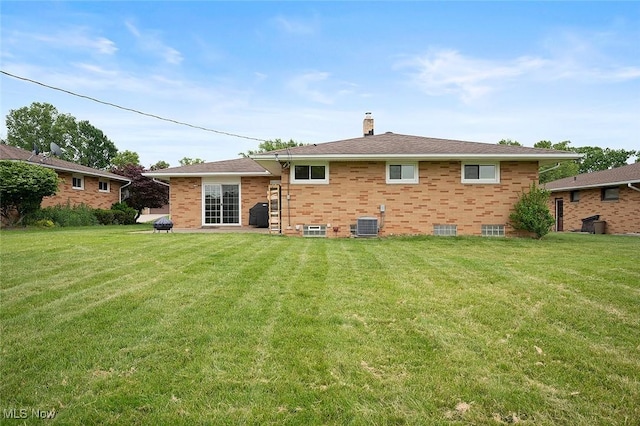 7278 Barton Hill Dr, Parma, OH 44129 - rear view of house with a chimney, a lawn, central AC unit, and brick siding