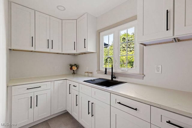 21262 S Woodland Rd, Shaker Heights, OH 44122 - kitchen with a sink, white cabinets, and light stone counters