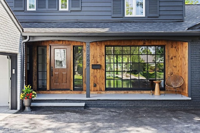 21262 S Woodland Rd, Shaker Heights, OH 44122 - doorway to property with roof with shingles