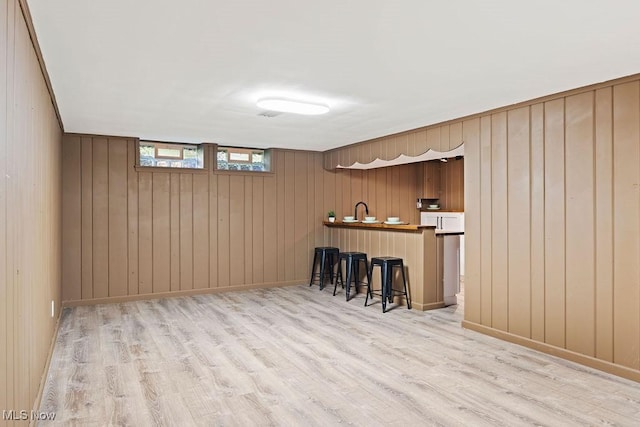 21262 S Woodland Rd, Shaker Heights, OH 44122 - bar area featuring light wood finished floors, wooden walls, and a sink