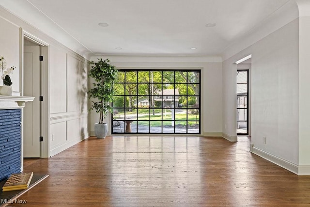 21262 S Woodland Rd, Shaker Heights, OH 44122 - unfurnished living room featuring hardwood / wood-style flooring, baseboards, and a fireplace
