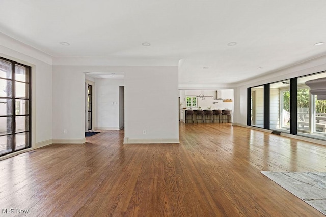 21262 S Woodland Rd, Shaker Heights, OH 44122 - unfurnished living room featuring wood finished floors and baseboards