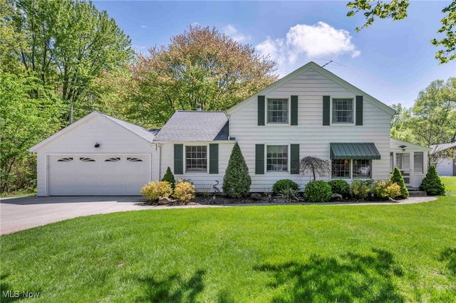 11483 Robson Rd, Grafton, OH 44044 - traditional home with concrete driveway, a front yard, and a garage