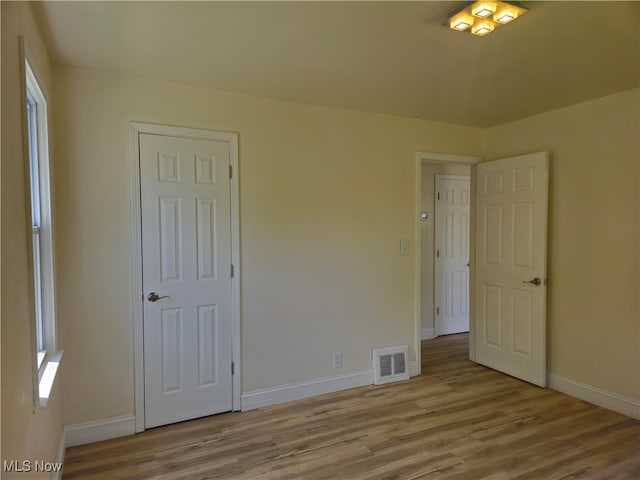 5200 Catherine St, Maple Heights, OH 44137 - unfurnished bedroom featuring wood finished floors and baseboards