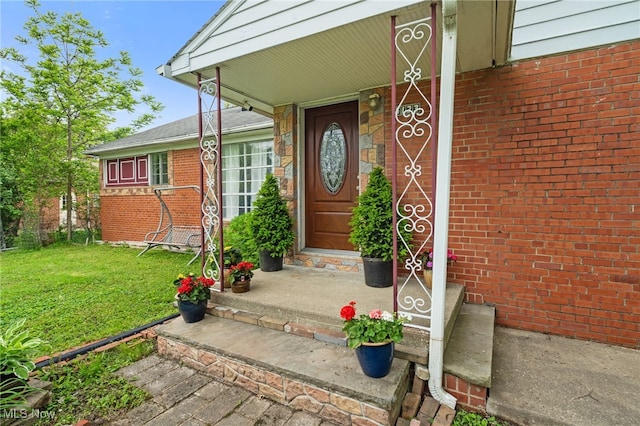 6123 Wilson Mills Rd, Highland Heights, OH 44143 - property entrance with a yard, a porch, and brick siding