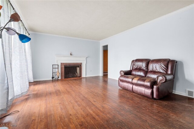6123 Wilson Mills Rd, Highland Heights, OH 44143 - living area featuring wood finished floors, a brick fireplace, crown molding, and baseboards