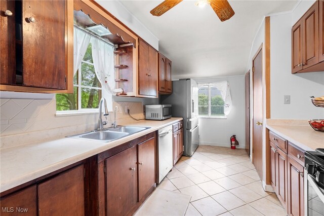 6123 Wilson Mills Rd, Highland Heights, OH 44143 - kitchen featuring a sink, appliances with stainless steel finishes, light countertops, and light tile patterned floors