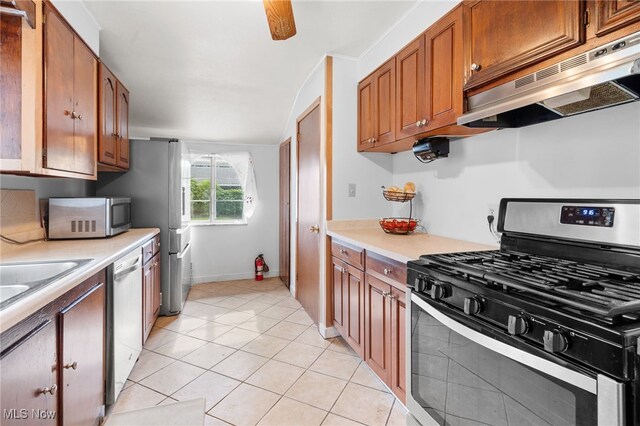 6123 Wilson Mills Rd, Highland Heights, OH 44143 - kitchen with stainless steel appliances, ventilation hood, light countertops, and brown cabinetry