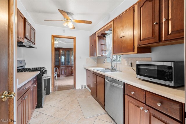 6123 Wilson Mills Rd, Highland Heights, OH 44143 - kitchen featuring stainless steel appliances, ceiling fan, a sink, under cabinet range hood, and light countertops