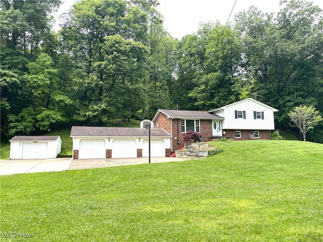 1355 Congress Rd, Belpre, OH 45714 - split level home featuring a front yard, brick siding, and a garage