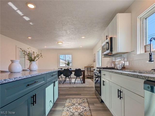 3509 Jerrold Blvd, Brunswick, OH 44212 - kitchen with appliances with stainless steel finishes, white cabinetry, light stone counters, dark wood-style floors, and recessed lighting
