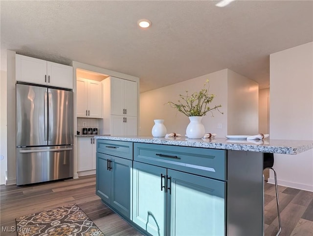 3509 Jerrold Blvd, Brunswick, OH 44212 - kitchen featuring freestanding refrigerator, white cabinets, dark wood-style floors, a textured ceiling, and recessed lighting