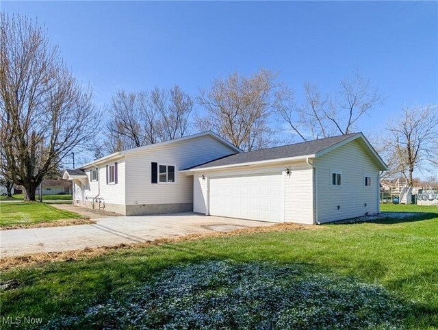 3509 Jerrold Blvd, Brunswick, OH 44212 - view of side of property with a garage, a lawn, and concrete driveway