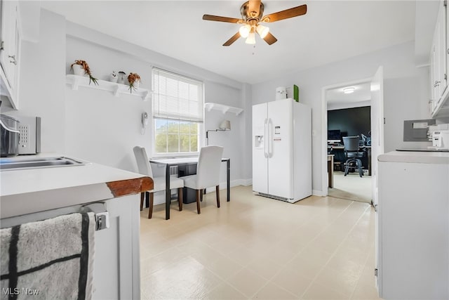 13800 Fairhill Rd Unit 418, Shaker Heights, OH 44120 - kitchen featuring white refrigerator with ice dispenser, ceiling fan, a desk, white cabinets, and open shelves