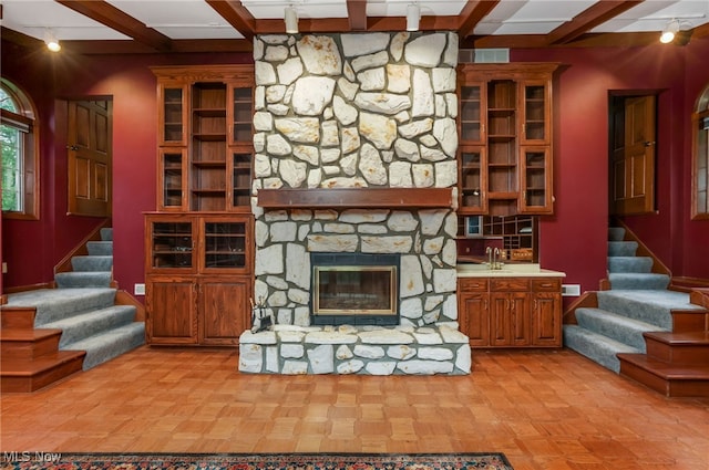 2015 Dunzweiler Dr, Zanesville, OH 43701 - unfurnished living room with stairs, beam ceiling, and a fireplace