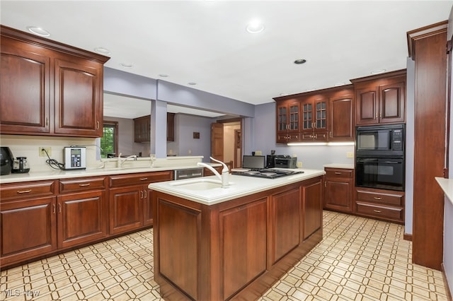 2015 Dunzweiler Dr, Zanesville, OH 43701 - kitchen featuring black appliances, light countertops, a sink, glass insert cabinets, and recessed lighting