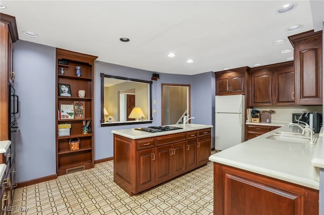 2015 Dunzweiler Dr, Zanesville, OH 43701 - kitchen with freestanding refrigerator, light countertops, gas stovetop, a sink, and recessed lighting