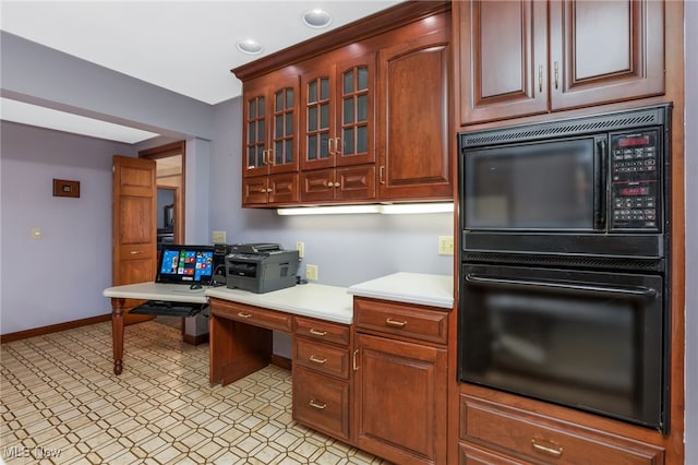 2015 Dunzweiler Dr, Zanesville, OH 43701 - kitchen with black appliances, light countertops, glass insert cabinets, and baseboards