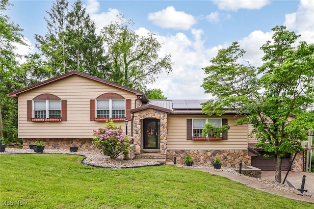 2015 Dunzweiler Dr, Zanesville, OH 43701 - split level home featuring stone siding, solar panels, a front yard, and metal roof