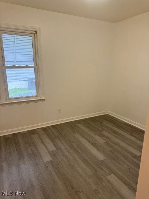 1090 Hartford Ave, Akron, OH 44320 - unfurnished room with dark wood finished floors and baseboards