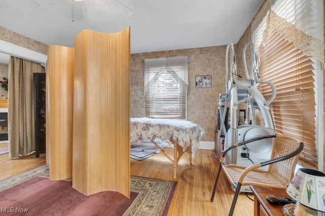 7285 Center St, Mentor, OH 44060 - sitting room with wood finished floors, wallpapered walls, and a ceiling fan