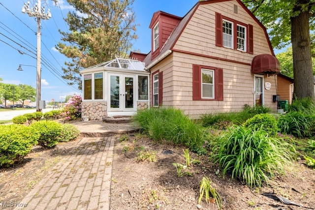 7285 Center St, Mentor, OH 44060 - view of front facade featuring french doors and a gambrel roof
