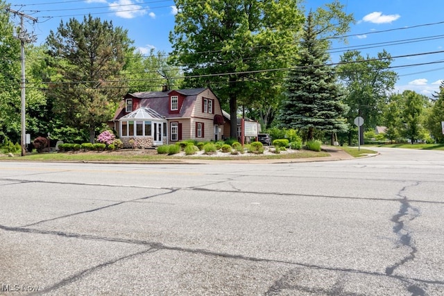7285 Center St, Mentor, OH 44060 - view of front of house with a gambrel roof and a chimney
