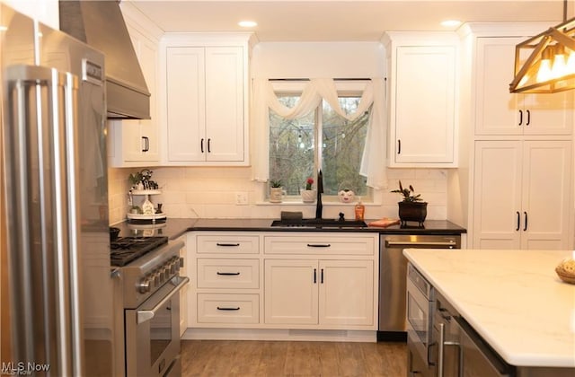 646 Ridgewood Dr, Coshocton, OH 43812 - kitchen with appliances with stainless steel finishes, a sink, decorative backsplash, white cabinetry, and recessed lighting