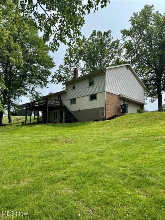 646 Ridgewood Dr, Coshocton, OH 43812 - rear view of property with stairs, a wooden deck, a chimney, and a yard