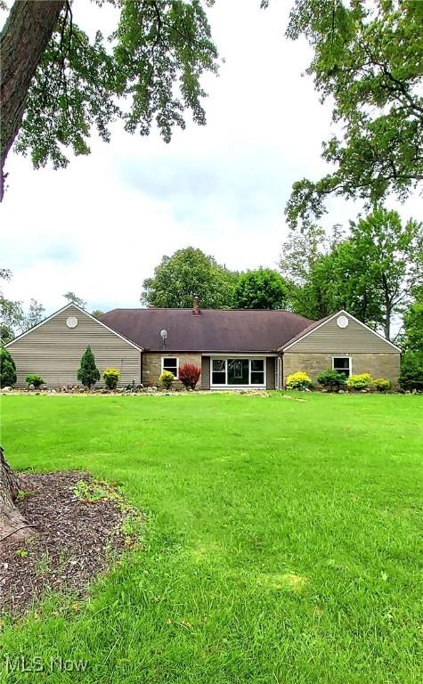 550 E Pleasant Valley Rd, Seven Hills, OH 44131 - back of property with a lawn and a chimney