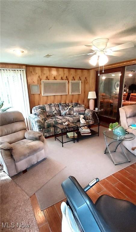 550 E Pleasant Valley Rd, Seven Hills, OH 44131 - living room with ceiling fan, wood walls, and wood finished floors