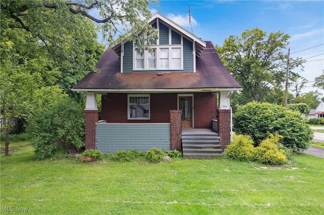 1284 Norton Ave, Norton, OH 44203 - bungalow with a porch, brick siding, and a front lawn