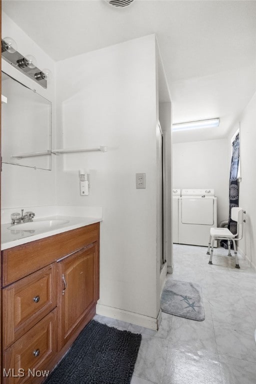 917 Park Ave SW, Canton, OH 44706 - full bathroom featuring washing machine and clothes dryer, vanity, a shower stall, and baseboards
