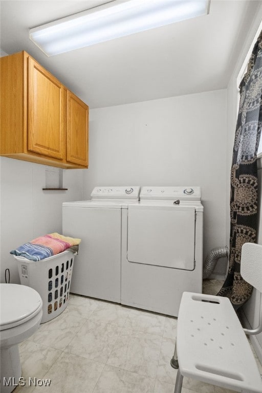 917 Park Ave SW, Canton, OH 44706 - bathroom featuring marble look tiles, washer and dryer, and toilet