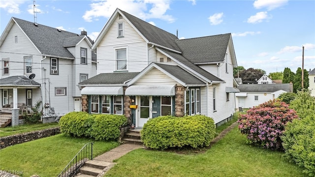 917 Park Ave SW, Canton, OH 44706 - traditional-style home featuring a front yard, a shingled roof, and entry steps