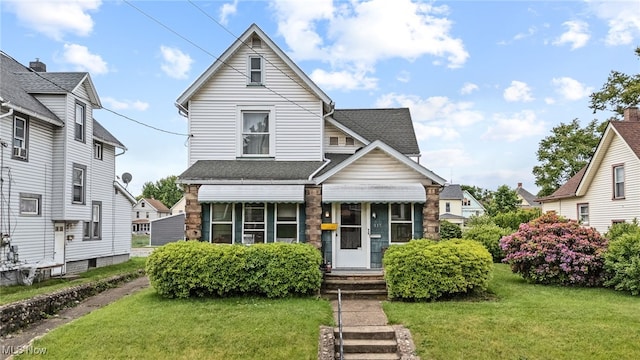 917 Park Ave SW, Canton, OH 44706 - view of front of house with a shingled roof and a front yard