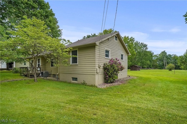890 E Liberty St, Hubbard, OH 44425 - view of side of home with a lawn and cooling unit