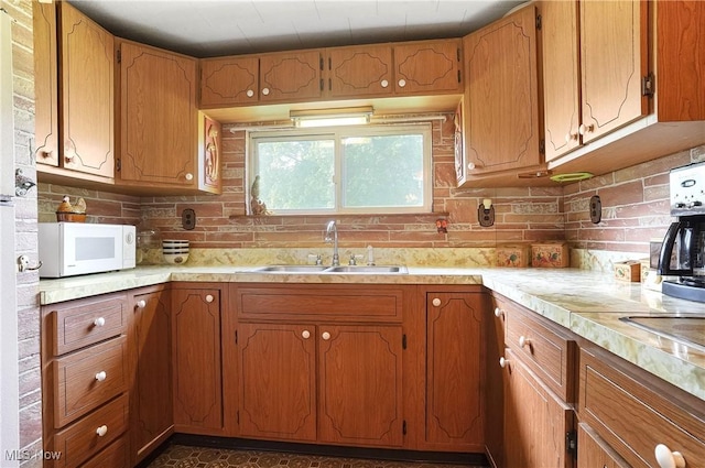 890 E Liberty St, Hubbard, OH 44425 - kitchen with white microwave, a sink, light countertops, and tasteful backsplash