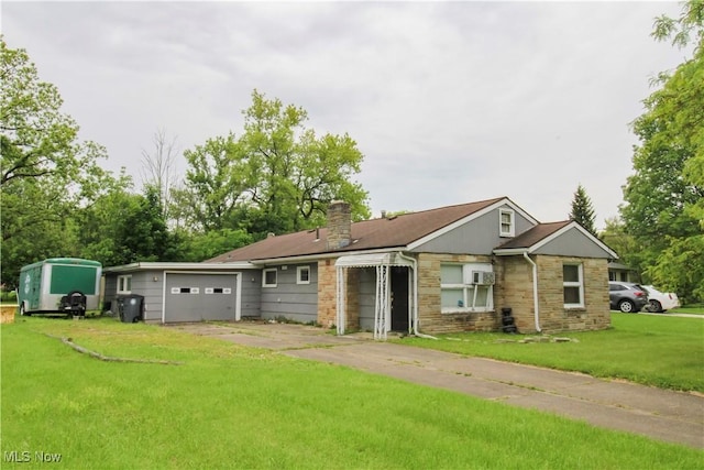 177 Sumner St, Oberlin, OH 44074 - view of front of property featuring stone siding, an attached garage, a chimney, a front lawn, and driveway