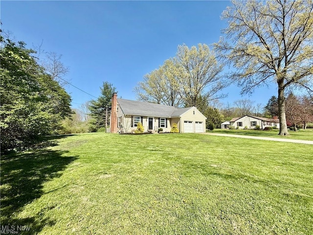 6911 Post Ln, Hudson, OH 44236 - view of front of house with an attached garage, a front lawn, a chimney, and driveway