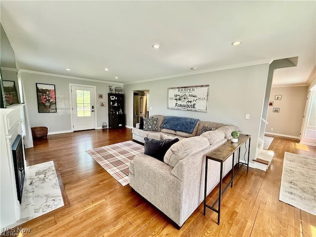 6911 Post Ln, Hudson, OH 44236 - living room with wood finished floors, baseboards, recessed lighting, ornamental molding, and a high end fireplace
