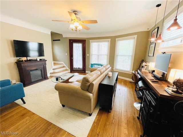 1630 Olivewood Ave, Lakewood, OH 44107 - living area featuring hardwood / wood-style flooring, a ceiling fan, an office area, and a glass covered fireplace