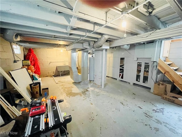 1630 Olivewood Ave, Lakewood, OH 44107 - unfinished below grade area featuring heating unit, stairs, concrete block wall, and water heater