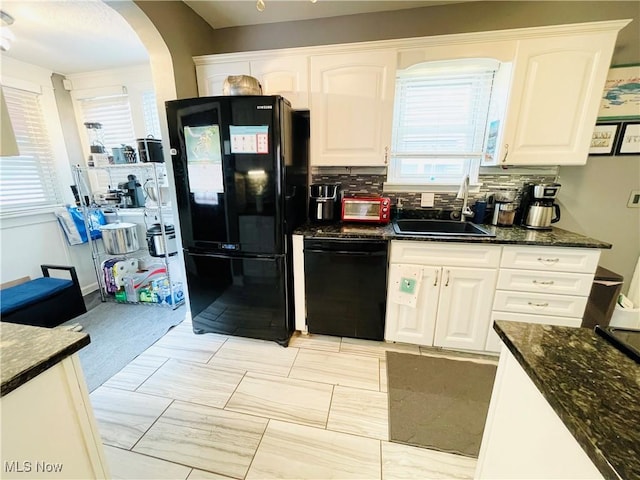 1630 Olivewood Ave, Lakewood, OH 44107 - kitchen with black appliances, a sink, arched walkways, and white cabinetry
