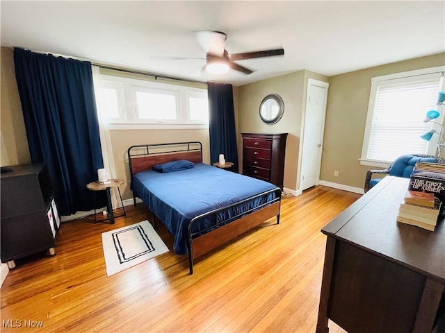 1630 Olivewood Ave, Lakewood, OH 44107 - bedroom featuring light wood-style flooring, multiple windows, ceiling fan, and baseboards